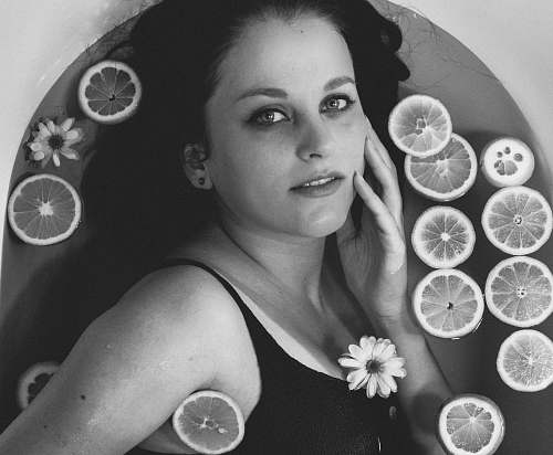 citrus fruit grayscale photography of woman in black top black-and-white